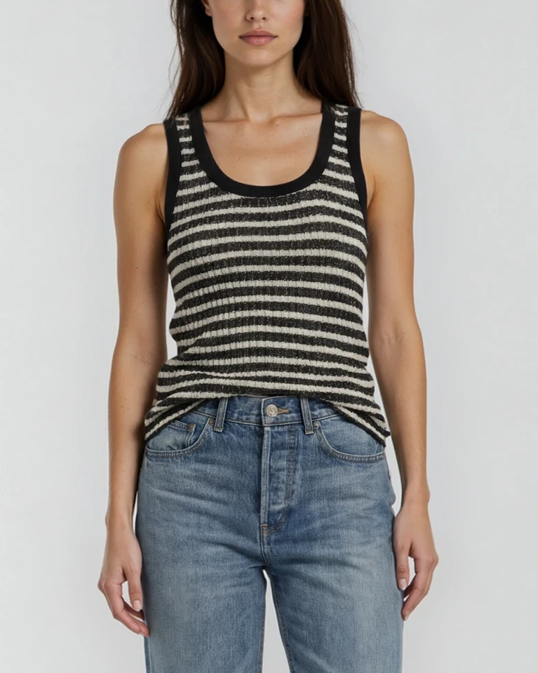 Female model wearing a striped black and white, cream tank top, and blue jeans on a white background. - Pete Collection
