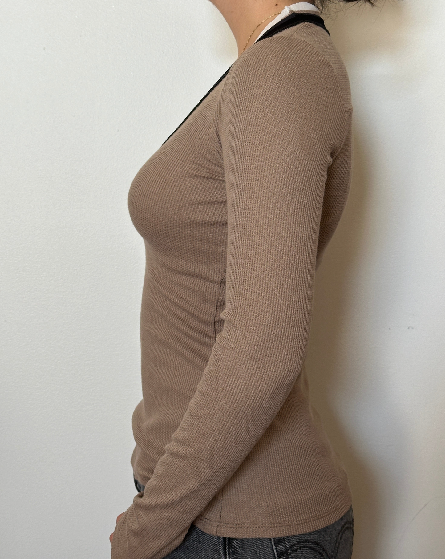 Female model wearing a bark (beige), white, and black long sleeve cotton thermal knit - Pete Collection