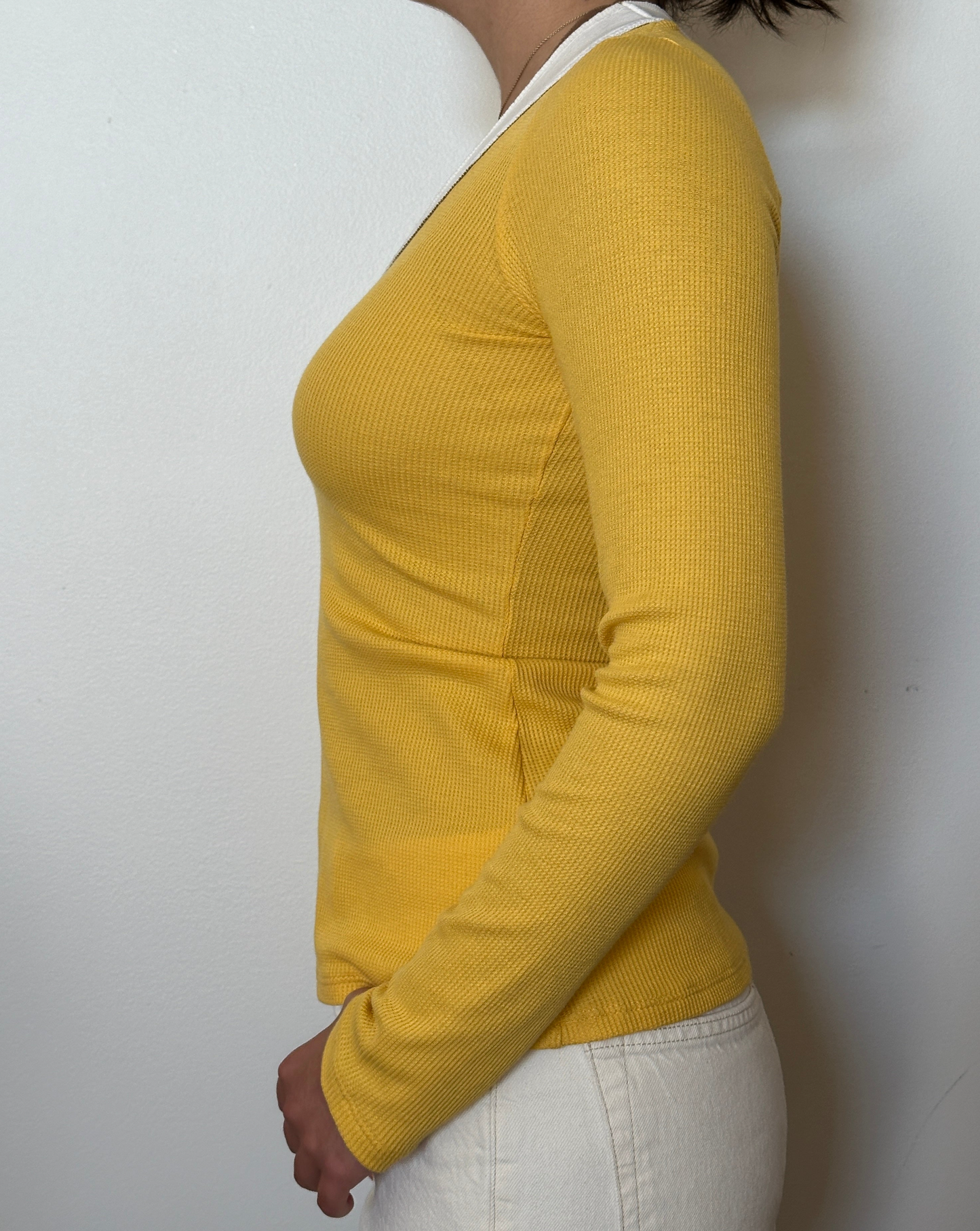 Female model wearing a tuscan sun (yellow), white, and bark (beige) long sleeve cotton thermal knit - Pete Collection