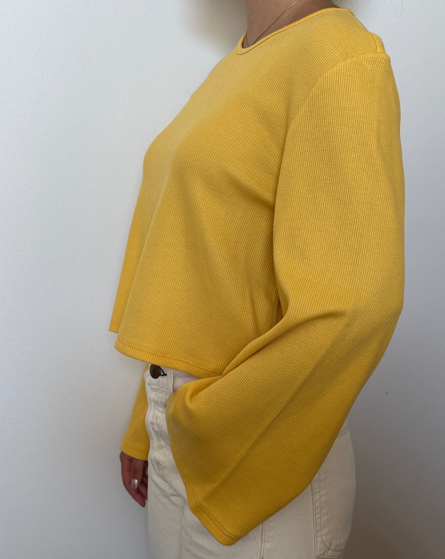 Female model wearing a tuscan sun (yellow) bell sleeve long sleeve cotton knit - Pete Collection