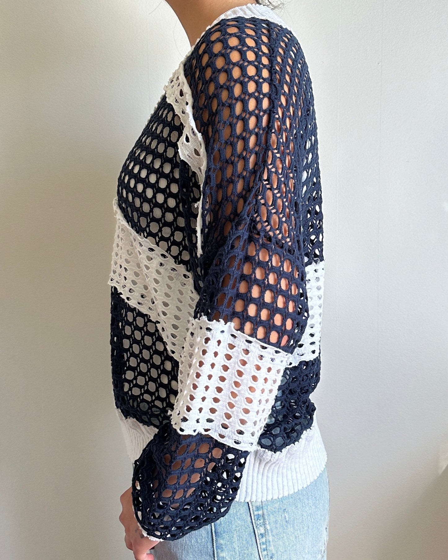Female model wearing a v neck coconut milk (white) and navy cotton crochet long sleeve top - Pete Collection