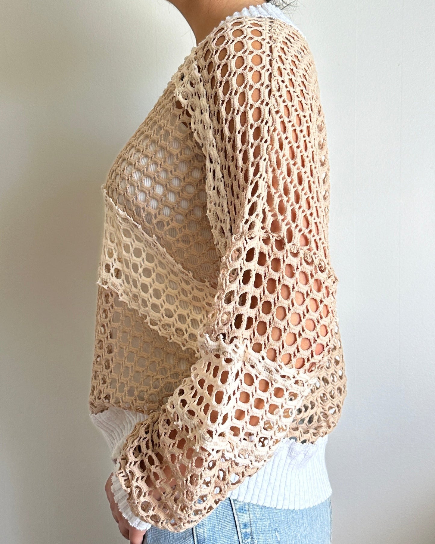 Female model wearing a v neck coconut milk (white) beige, and cream cotton crochet long sleeve top - Pete Collection