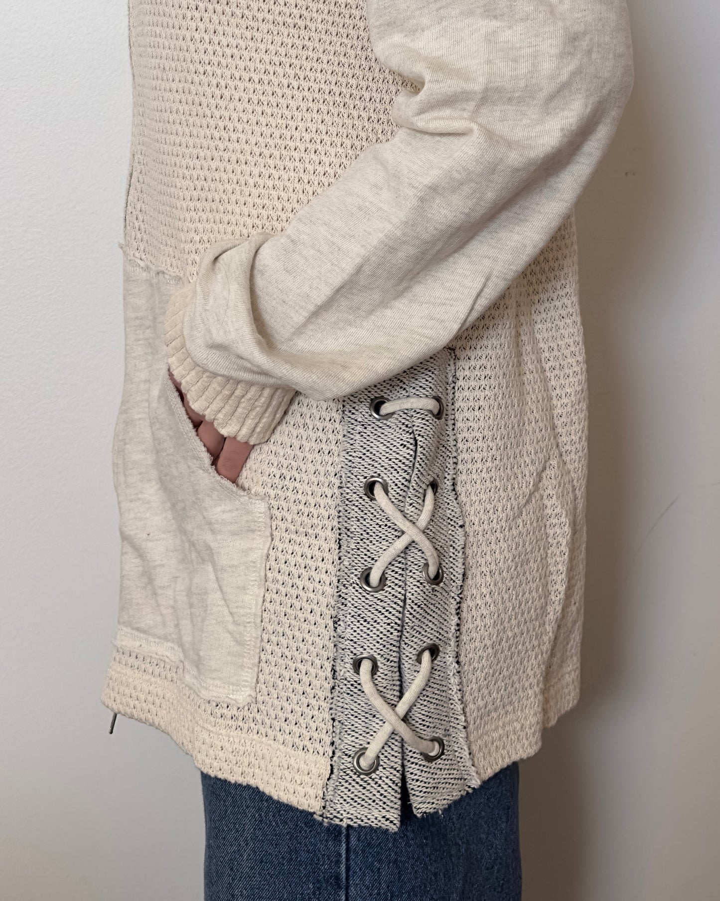 Female model wearing an oversized textured cotton jacket with patchwork sleeves and pockets and tied sides- Pete Collection