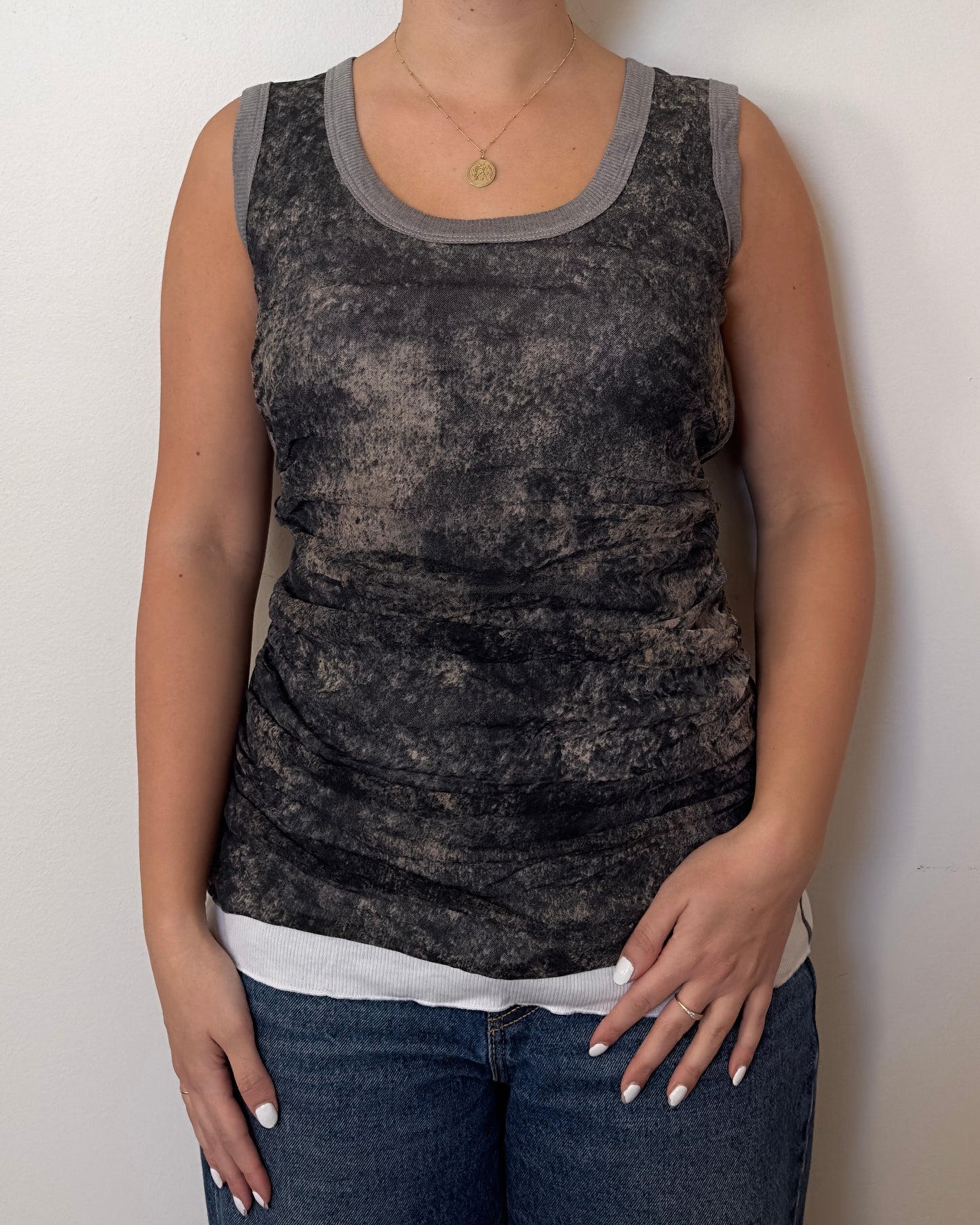 Female model wearing a cotton and mesh grey, white, and black tank top - Pete Collection