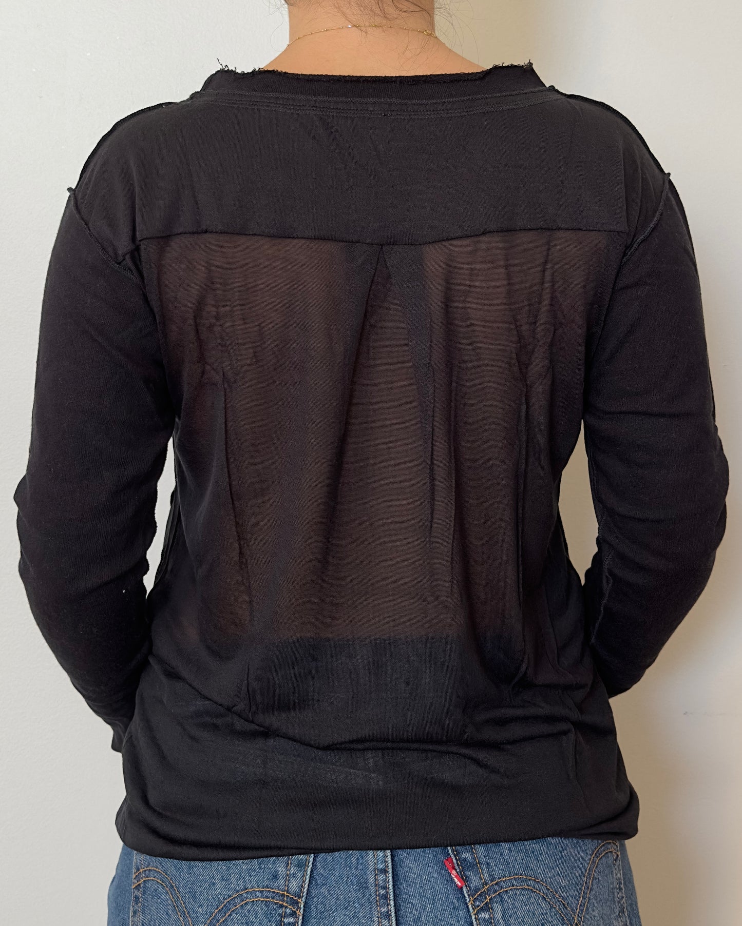 Female model wearing a cotton and mesh black long sleeve top with a mesh back - Pete Collection