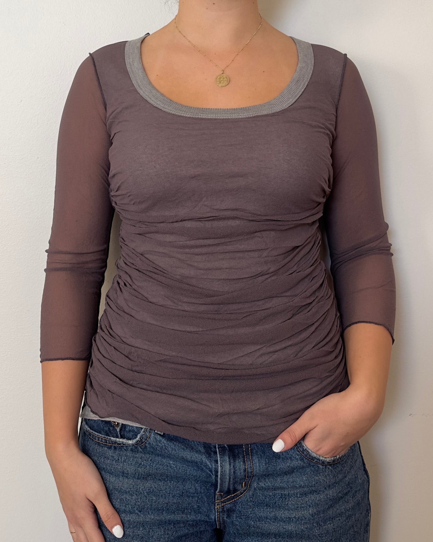 Female model wearing a mesh grey and purple long sleeve top with a scrunched mesh front and mesh sleeves and grey undershirt - Pete Collection