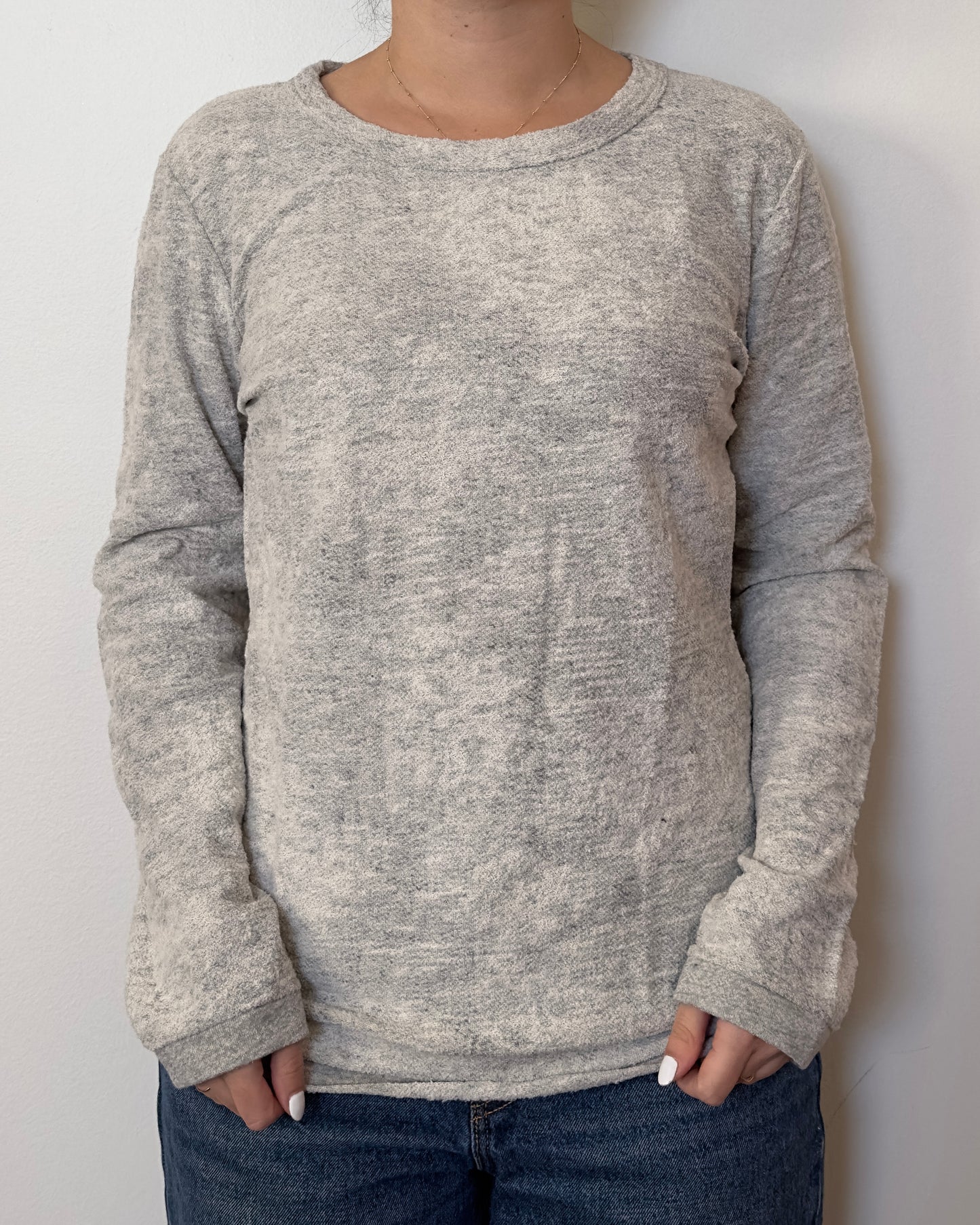 Female model wearing a long sleeve textured grey top - Pete Collection