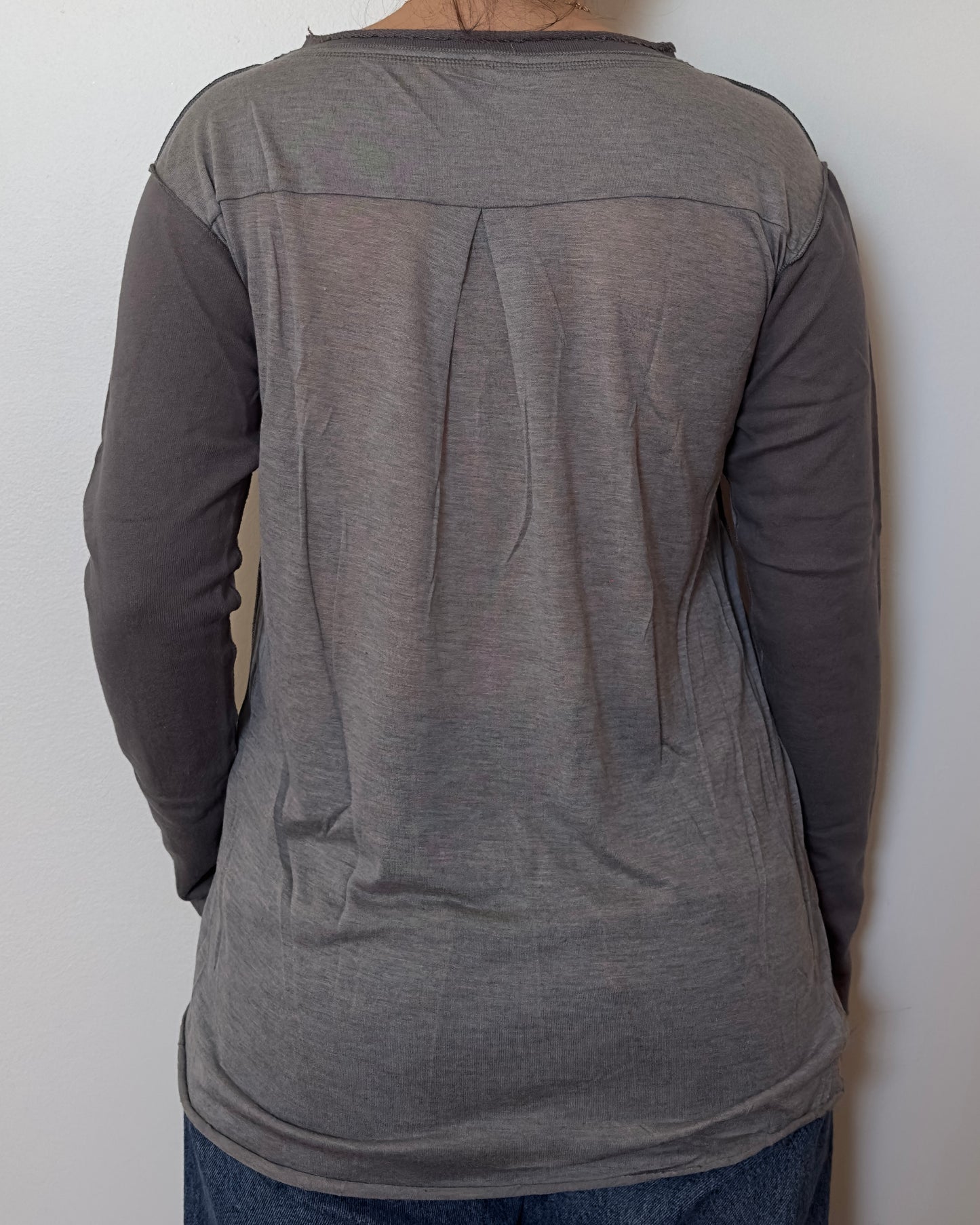 Female model wearing a cotton and mesh grey long sleeve top with a mesh back - Pete Collection