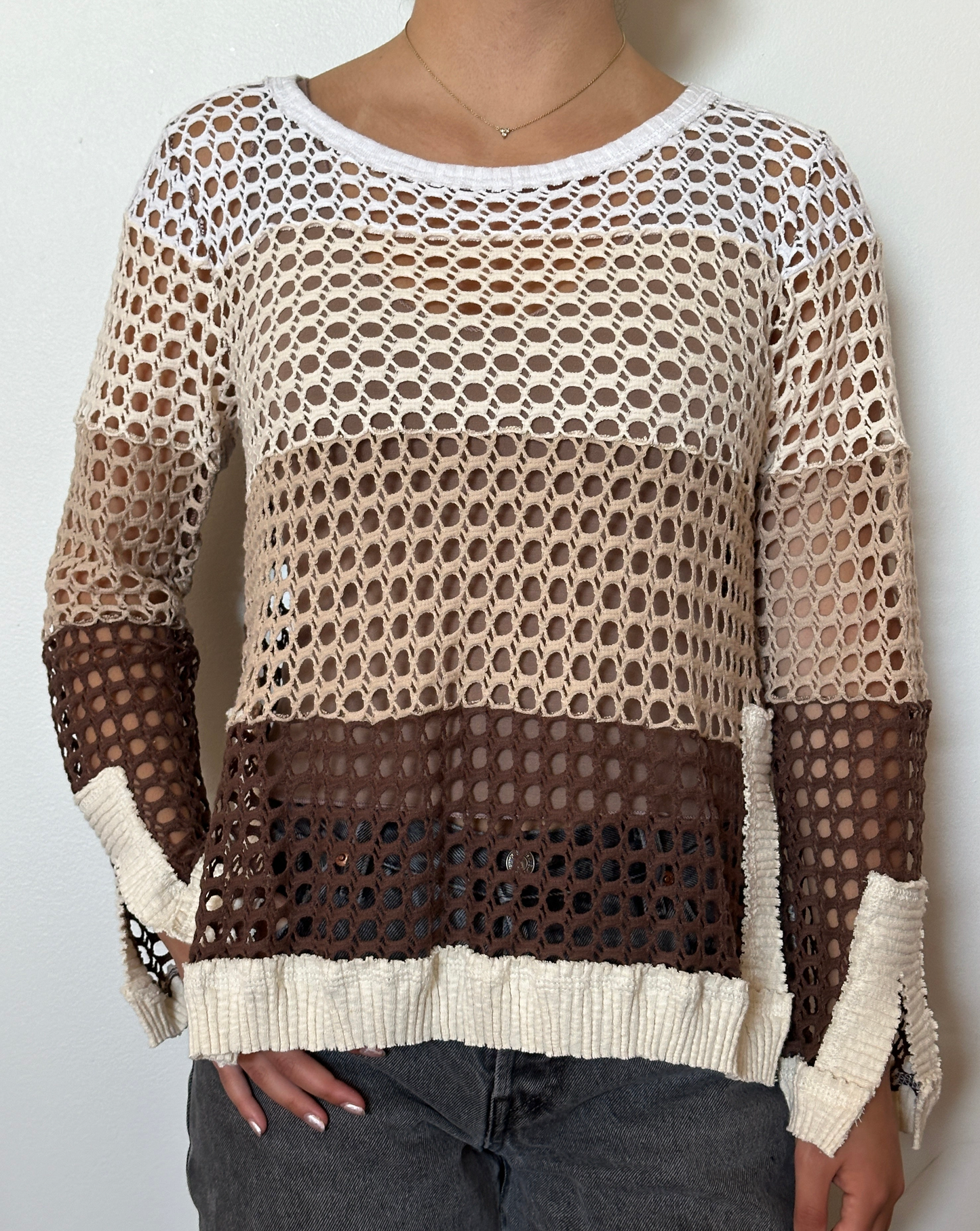 Female model wearing a crochet neutral, brown, beige, cream, and white long sleeve cotton knit with a crew neckline - Pete Collection
