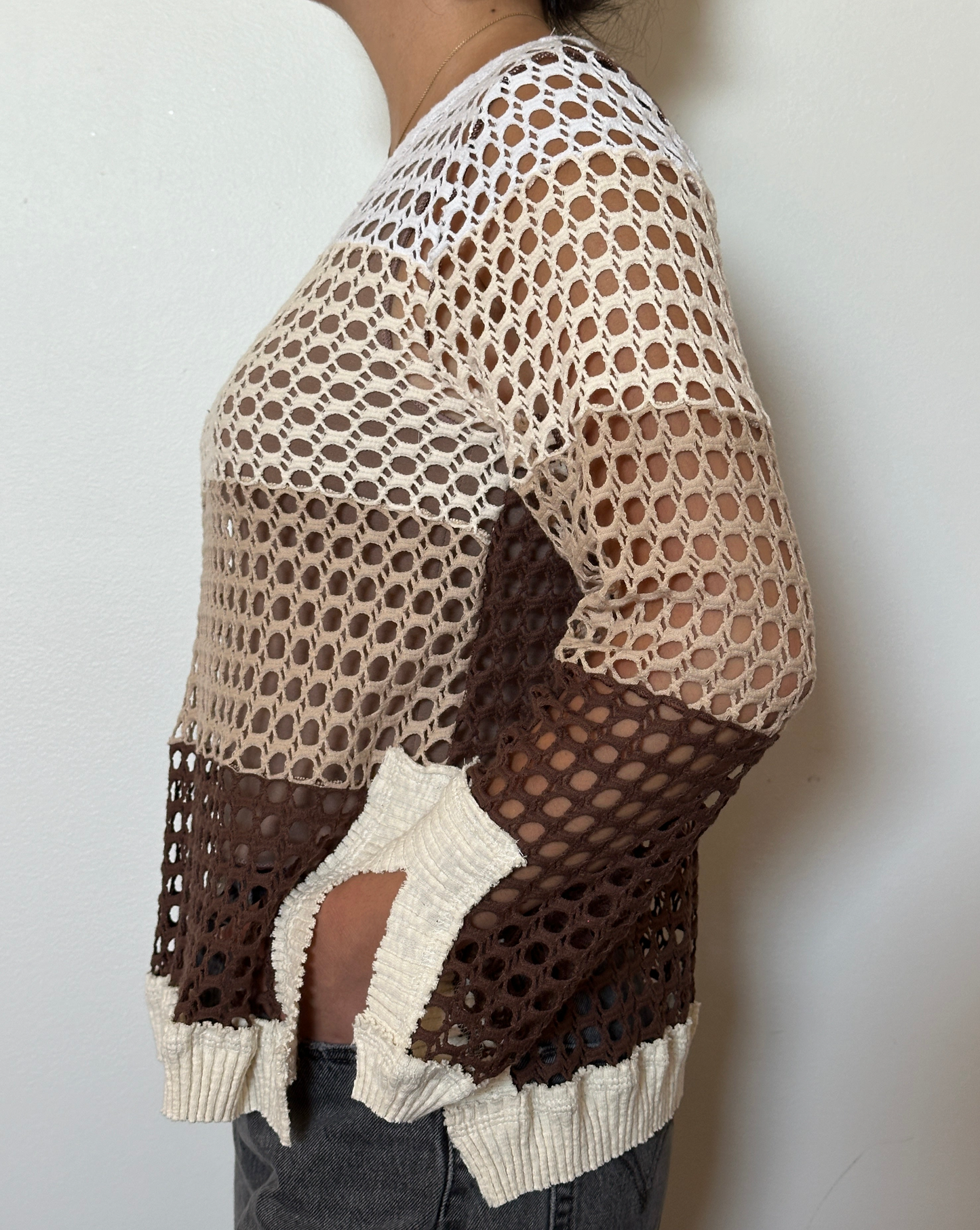 Female model wearing a crochet neutral, brown, beige, cream, and white long sleeve cotton knit with a crew neckline - Pete Collection