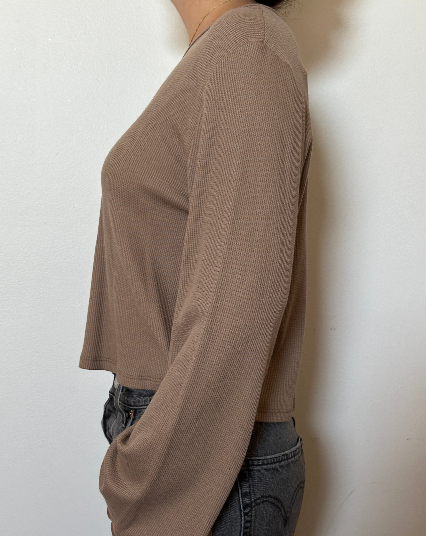 Female model wearing a bark (beige) bell sleeve long sleeve cotton knit - Pete Collection