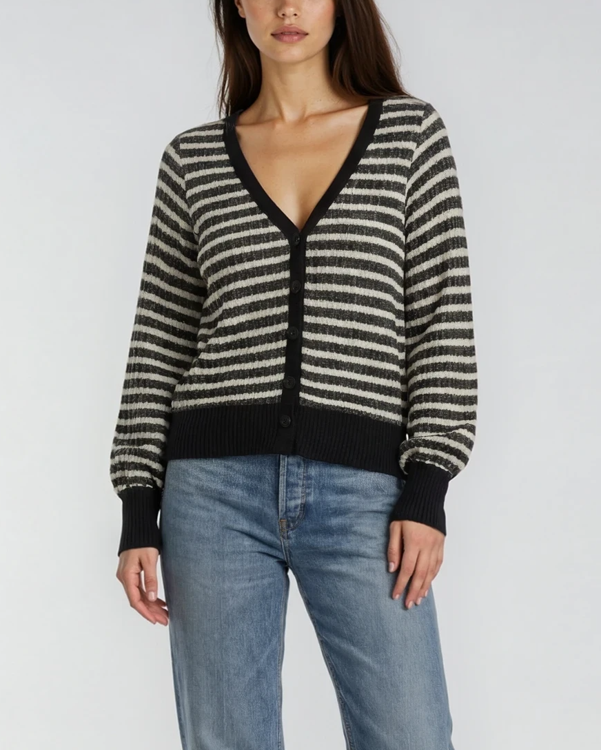 Woman wearing a striped black and white (ivory) sweater with jeans on a white background