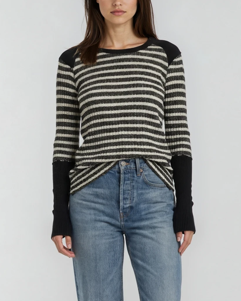 Image of a model wearing a black-and-white (ivory) striped raglan long-sleeve top with ribbed detailing, paired with jeans, on a white background. - Pete Collection