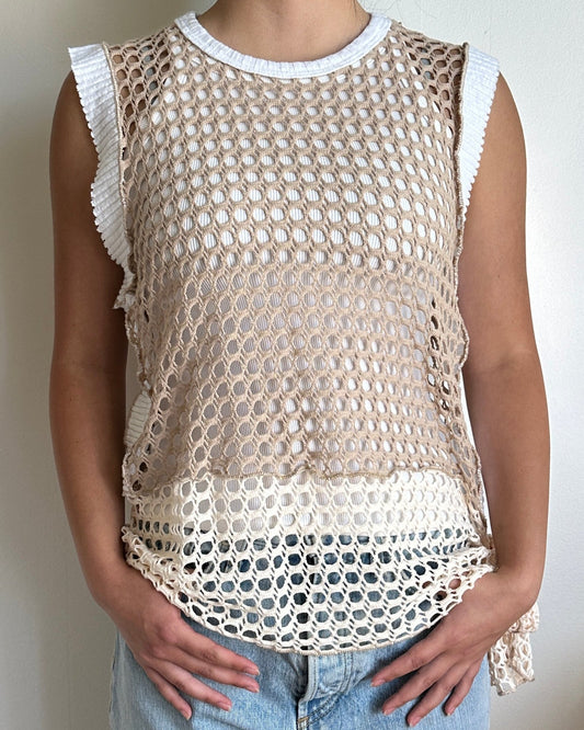 Female model wearing a sleeveless coconut milk (white), cream, and beige cotton crochet top with side knot - Pete Collection