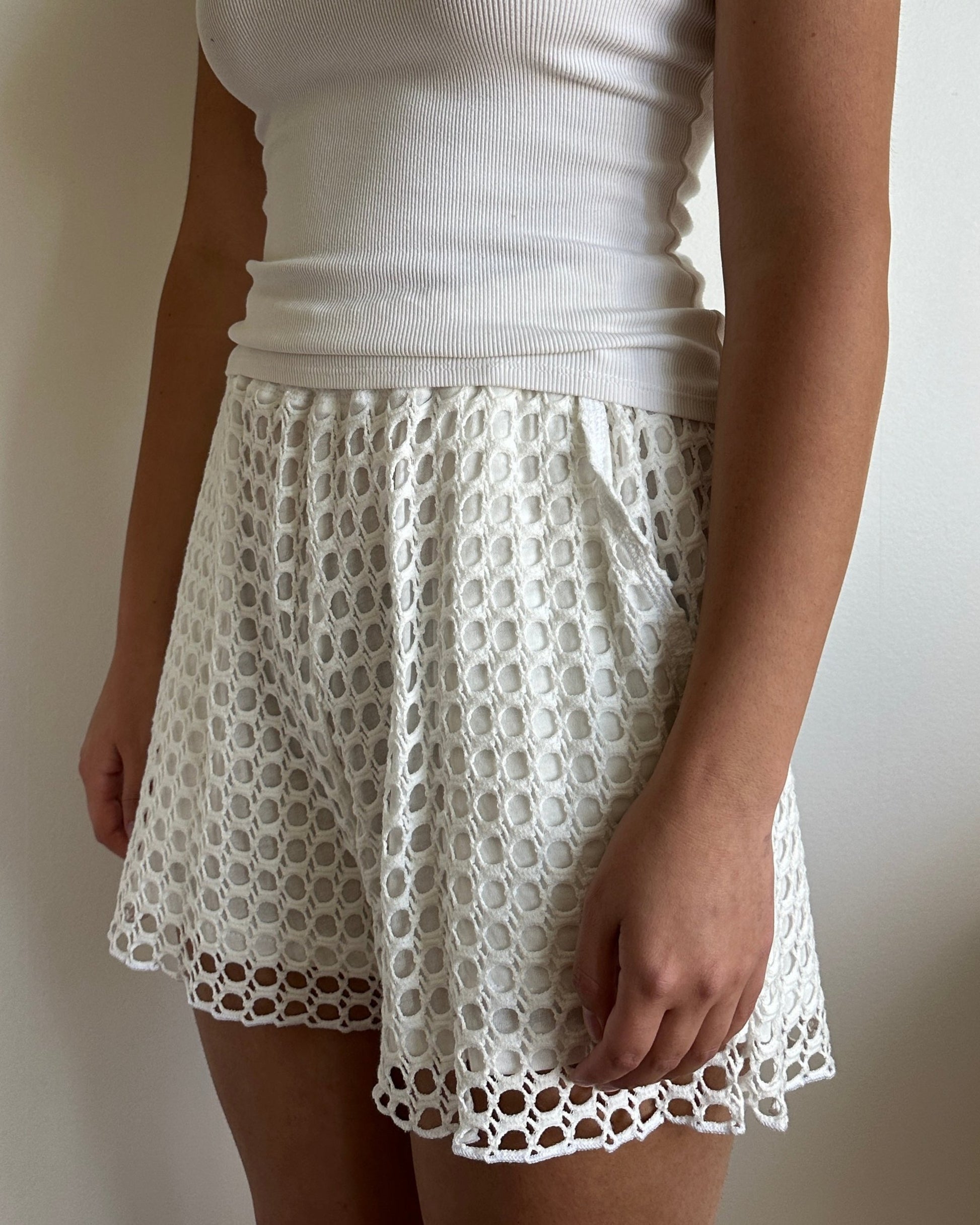 Female model wearing coconut milk (white) cotton crochet shorts (lounge/beach pants) - Pete Collection