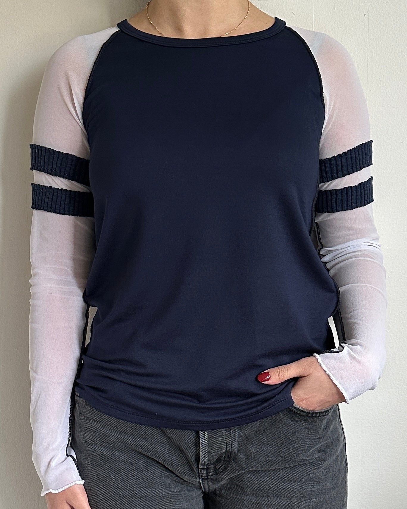 female model wearing a long sleeve baseball tee in navy with mesh sleeves. sporty and casual every day shirt. - Pete Collection