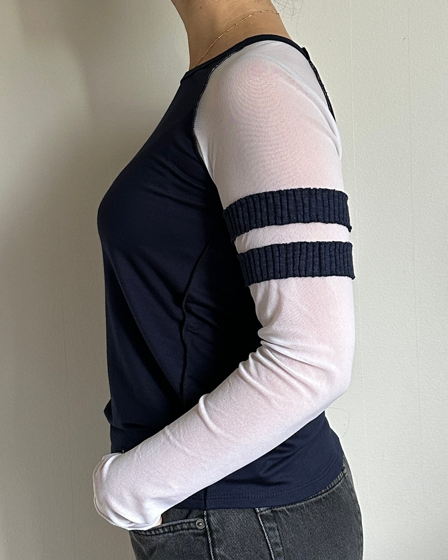 female model wearing a long sleeve baseball tee in navy with mesh sleeves. sporty and casual every day shirt. - Pete Collection