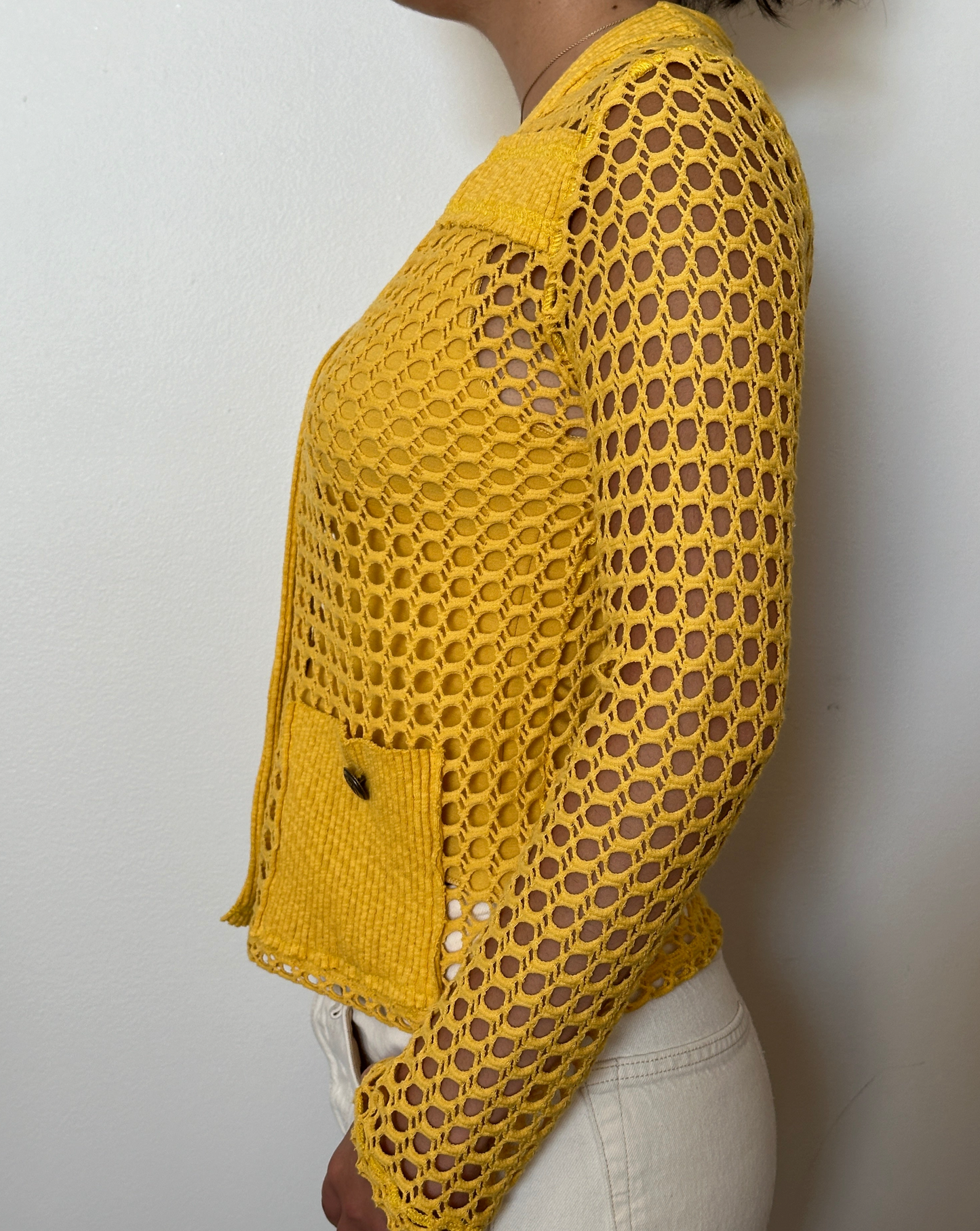 Female model wearing a tuscan sun (yellow) long sleeve cotton crochet cardigan with pockets and a tank top - Pete Collection